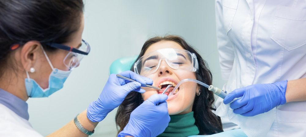 two-dentists-working-with-patient.jpg
